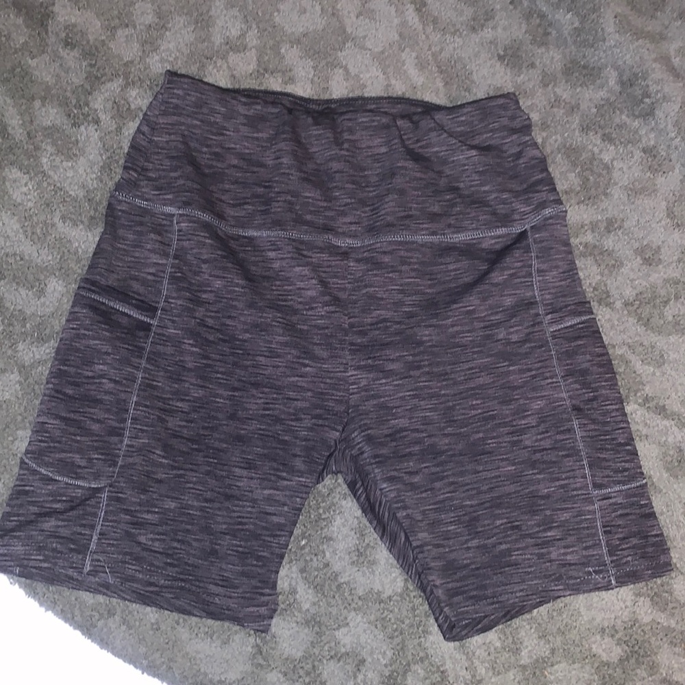 A pair of grey athletic shorts with pockets